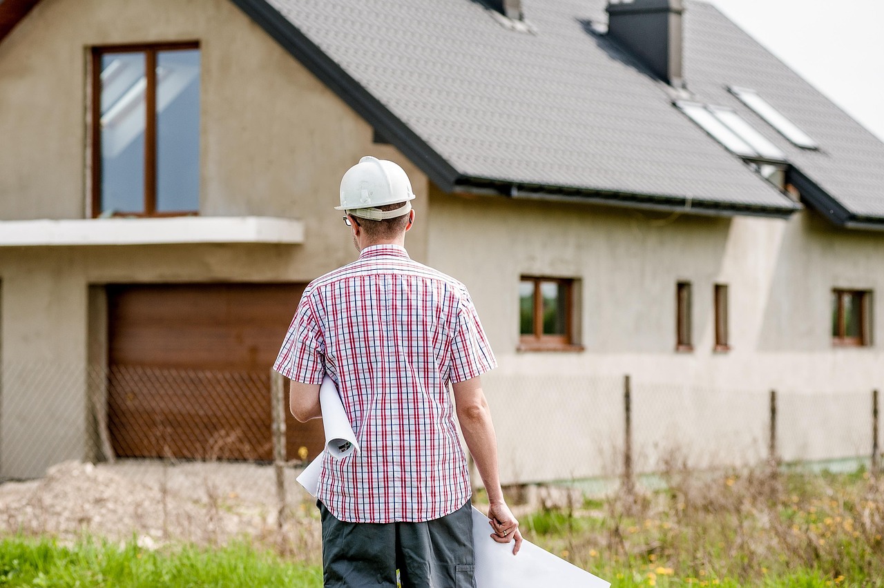 A professional roofing contractor reviewing plans on site